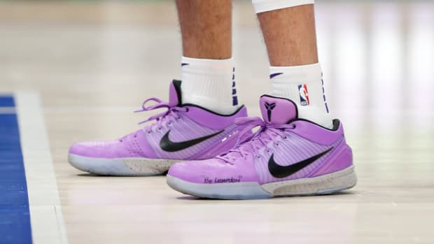 Devin Booker wears a pair of Nike Kobe 4 Protro in a violet colored PE.